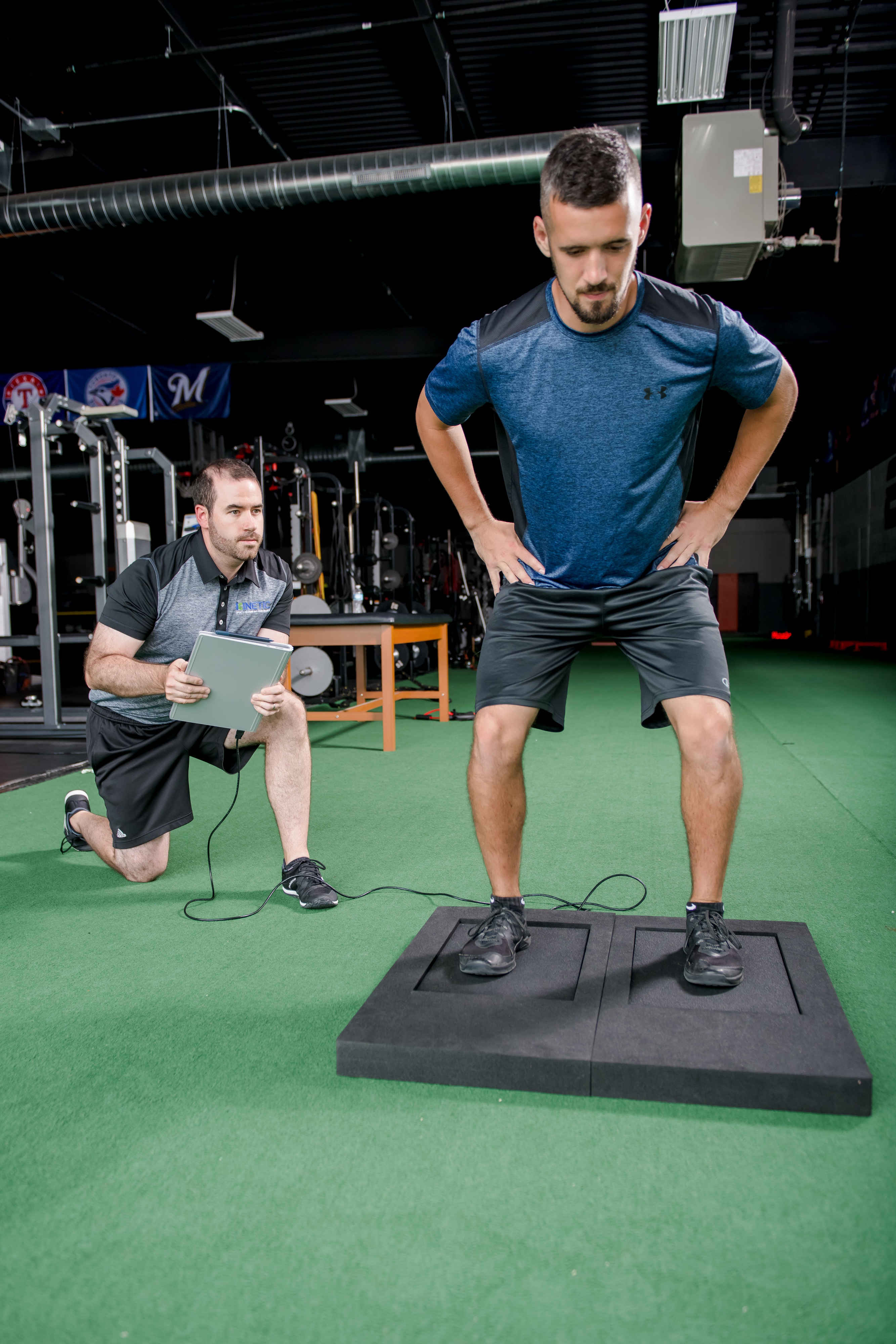 Physical therapist uses force plates to test an athlete.